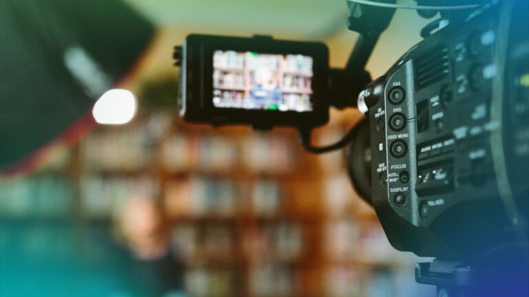 Behind-the-scenes view of a video production team filming on location with professional camera equipment